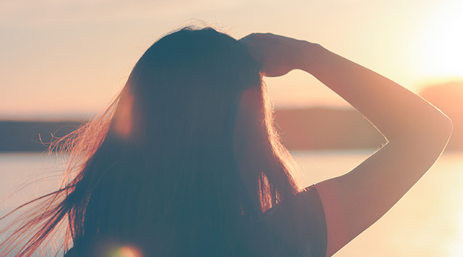 Image of woman looking of sunset